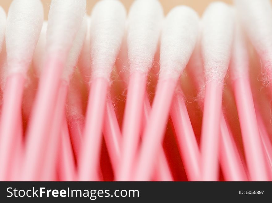 Line of cotton buds with pink plastic basis