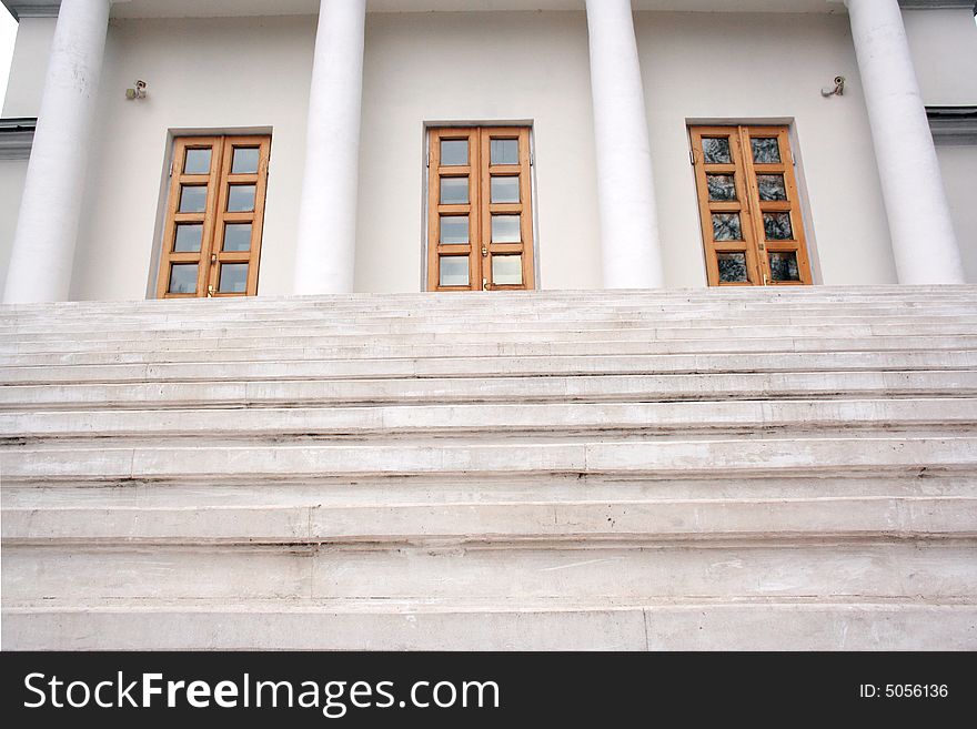 Marble stairs leading to three doors