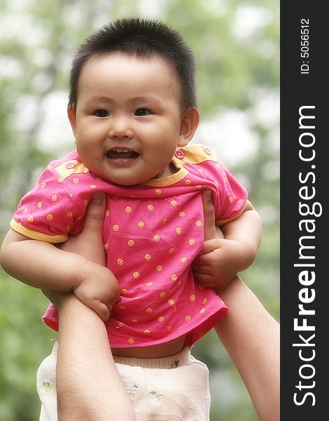 A chinese baby girl on the meadow
