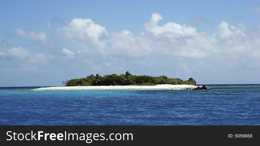 An isolated tropical island in the caribbean ocean. An isolated tropical island in the caribbean ocean