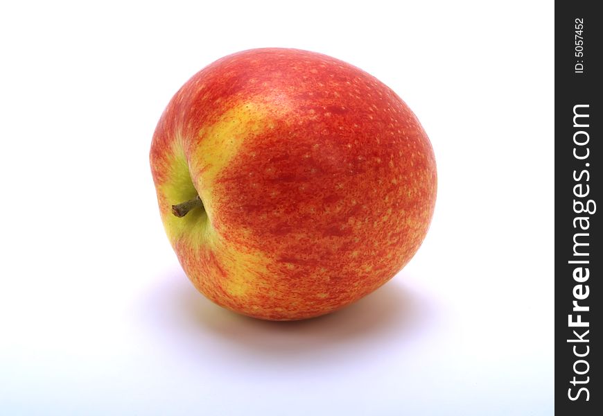 A tumbled fresh red apple on white background