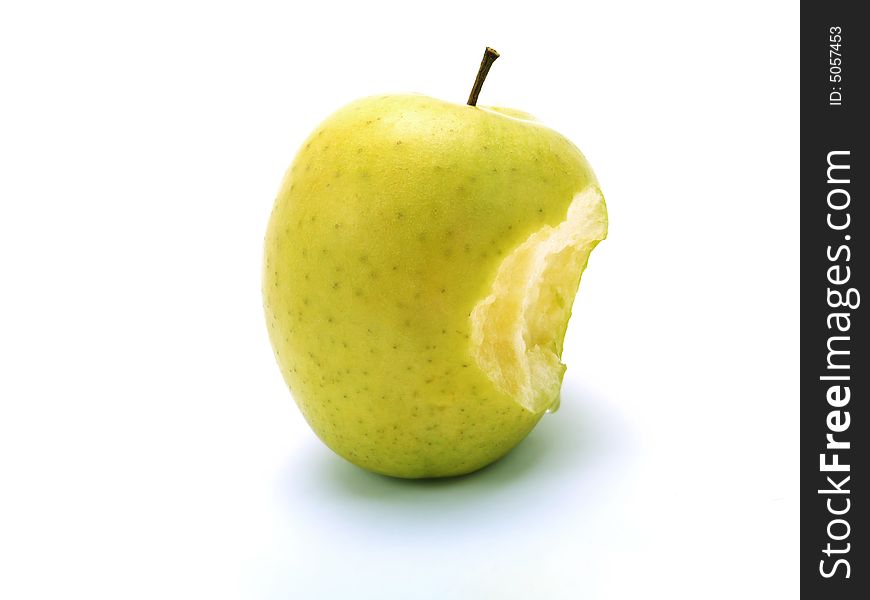 A bitten fresh green apple on white background. A bitten fresh green apple on white background