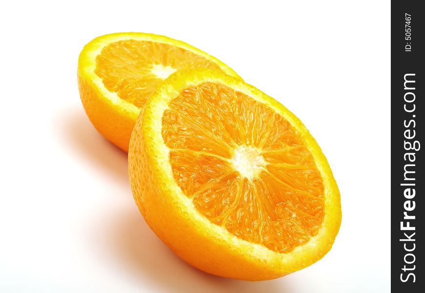 Two half fresh oranges on a white table. Two half fresh oranges on a white table