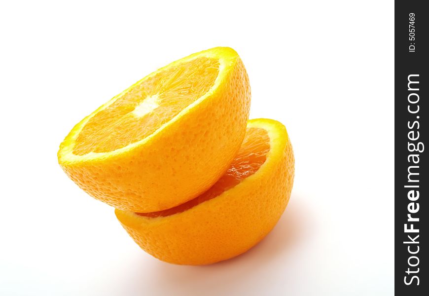 Two half fresh oranges form a tower. Two half fresh oranges form a tower