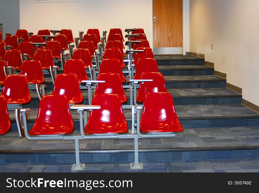 College classroom setting with red chairs