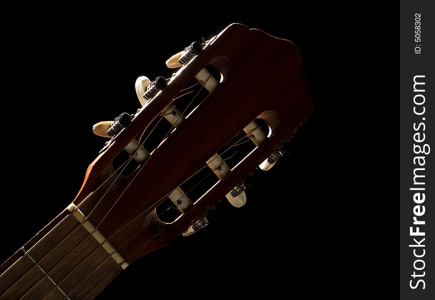 Cloze-up guitar's neck on black background