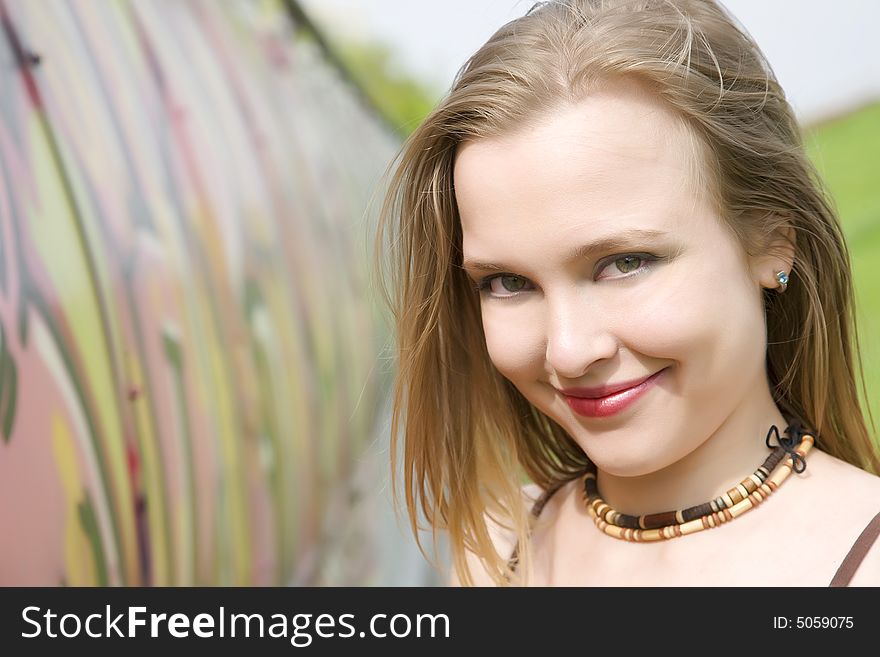 Young Lady Near The Graffiti Painted Wall. Young Lady Near The Graffiti Painted Wall