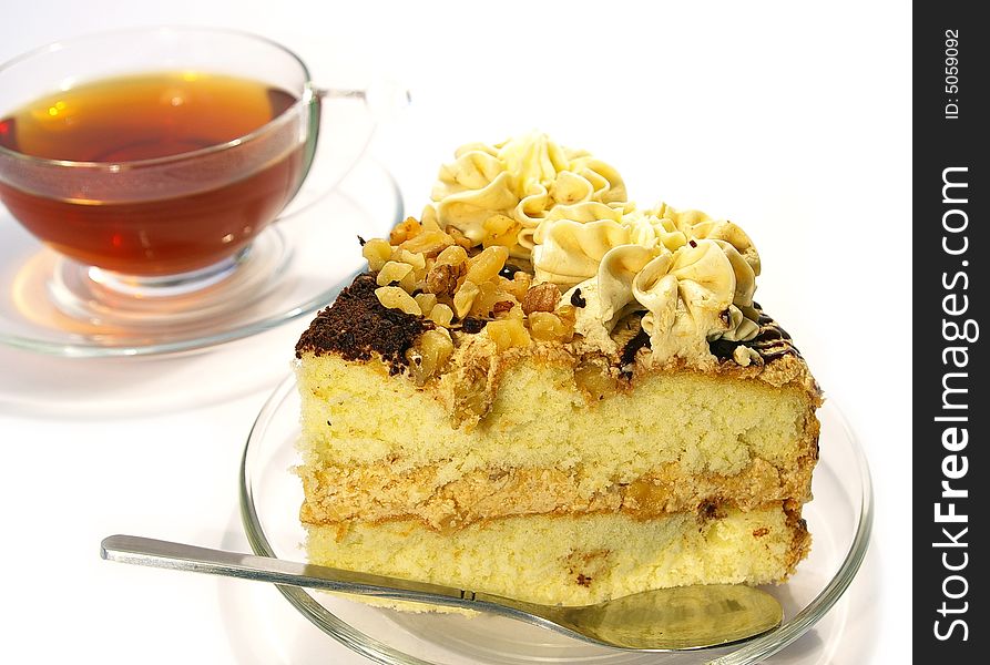 Cup of tea and cake isolated on white background