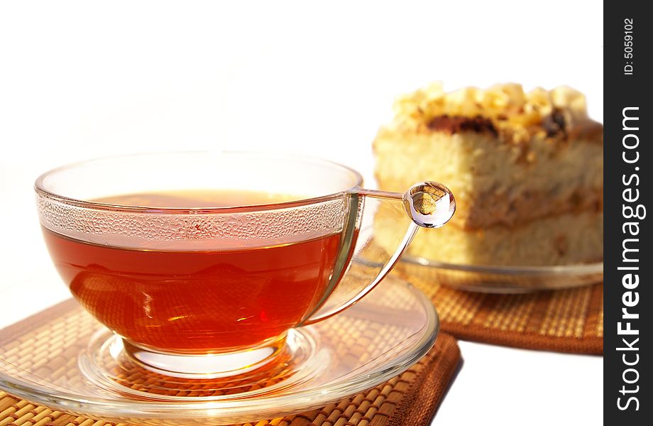 Cup of tea and cake isolated on white background