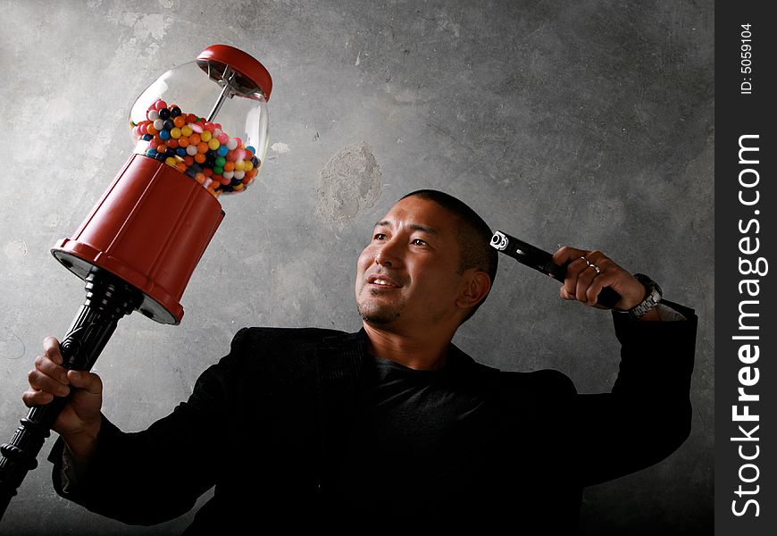 Funny Asian Man Robbing a Gum Ball Machine. Funny Asian Man Robbing a Gum Ball Machine