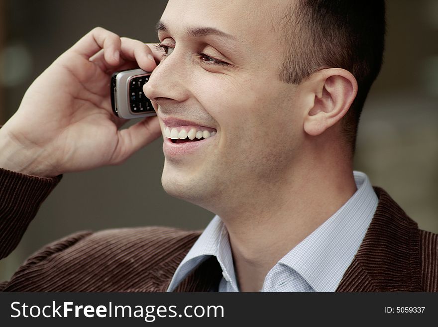 Young happy business man talking on the phone. Young happy business man talking on the phone