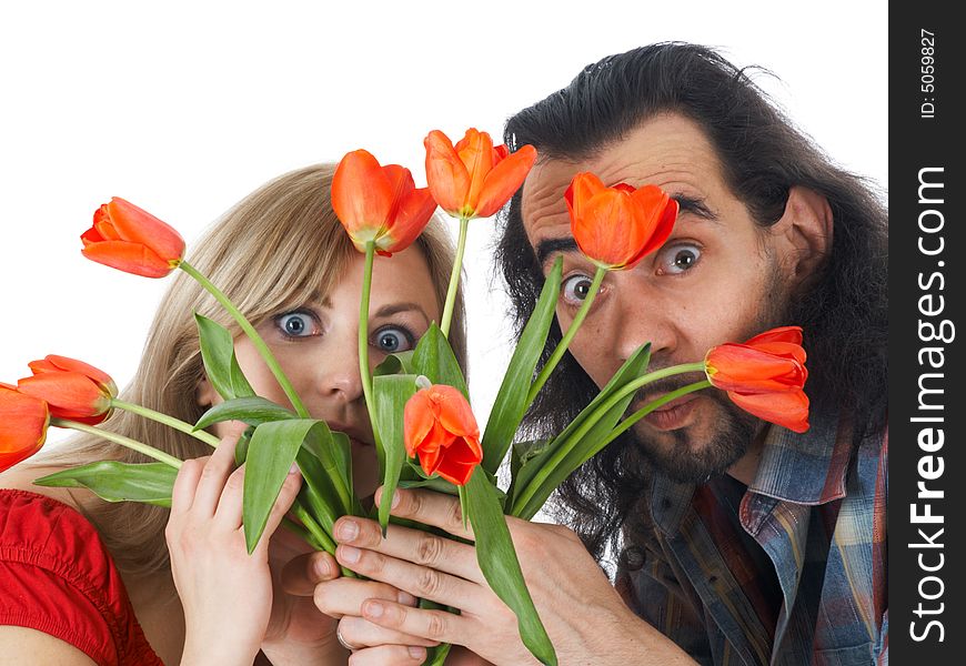 Girl and man hiding at red flowers. Girl and man hiding at red flowers