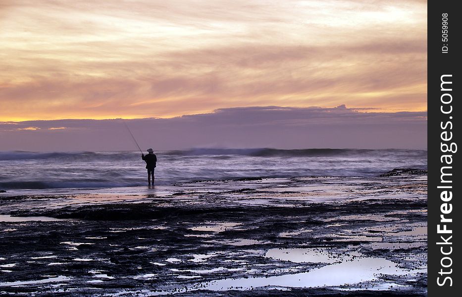 Fisherman on Mona Vale Beach in sunrise