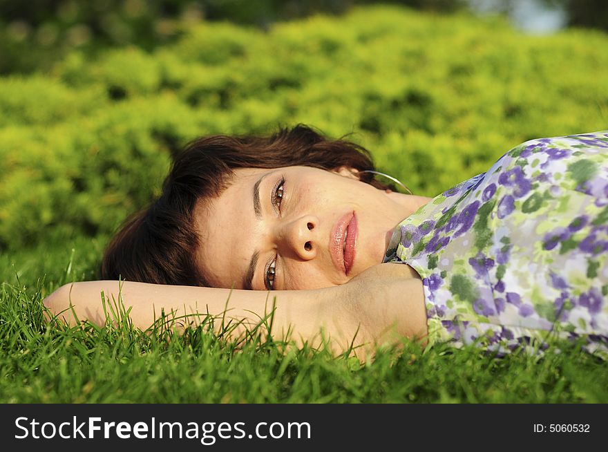 Young woman laid in grass. Young woman laid in grass