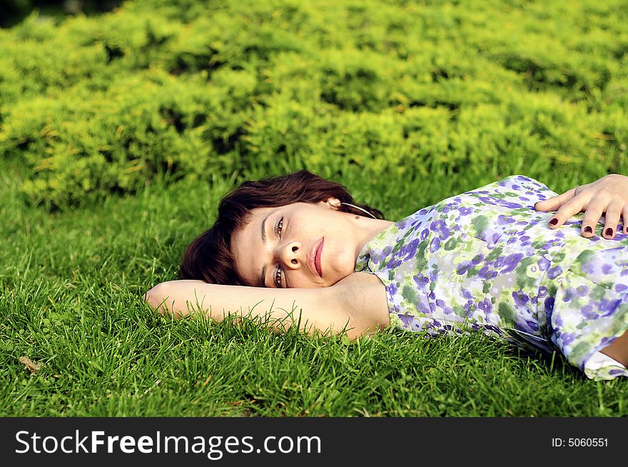 Young woman laid in grass