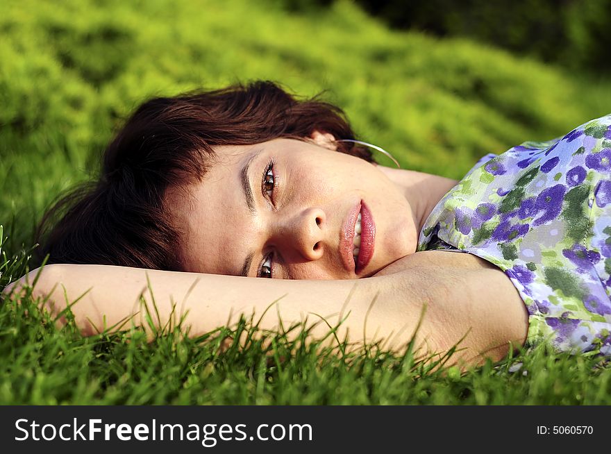 Young woman laid in grass. Young woman laid in grass