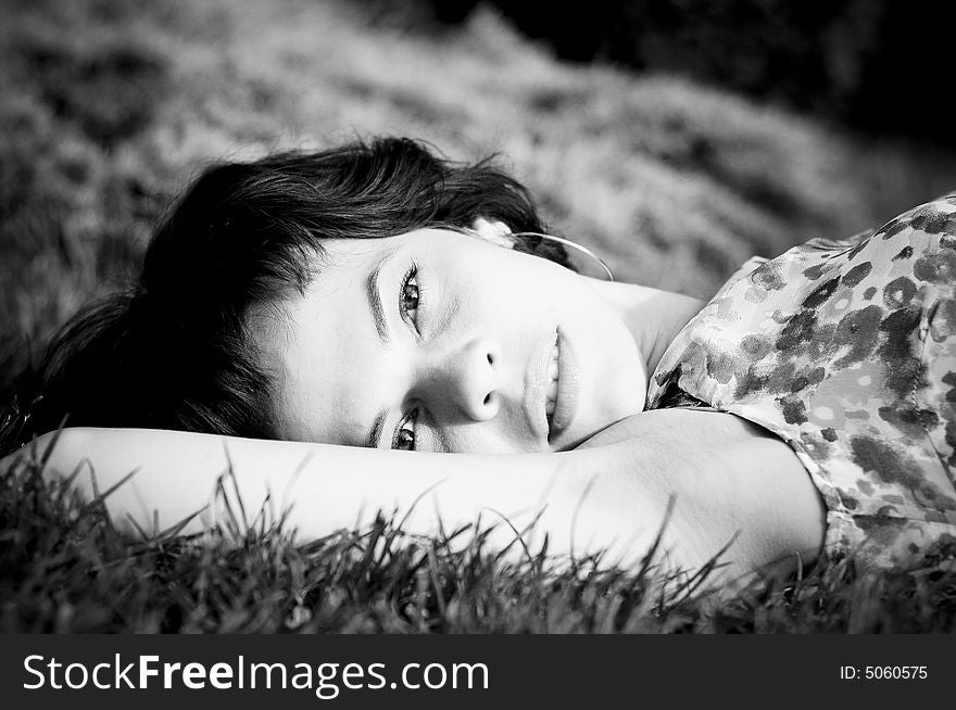 Young woman laid in grass