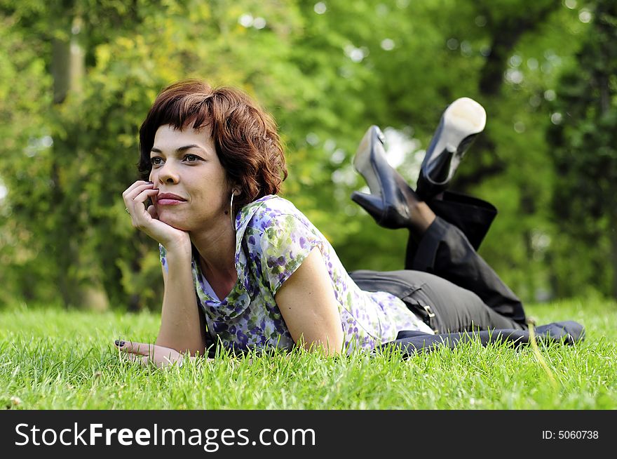 Young woman laid in grass