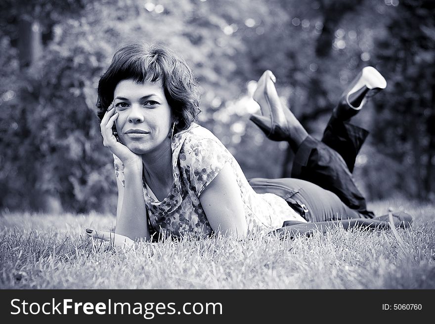 Young woman laid in grass