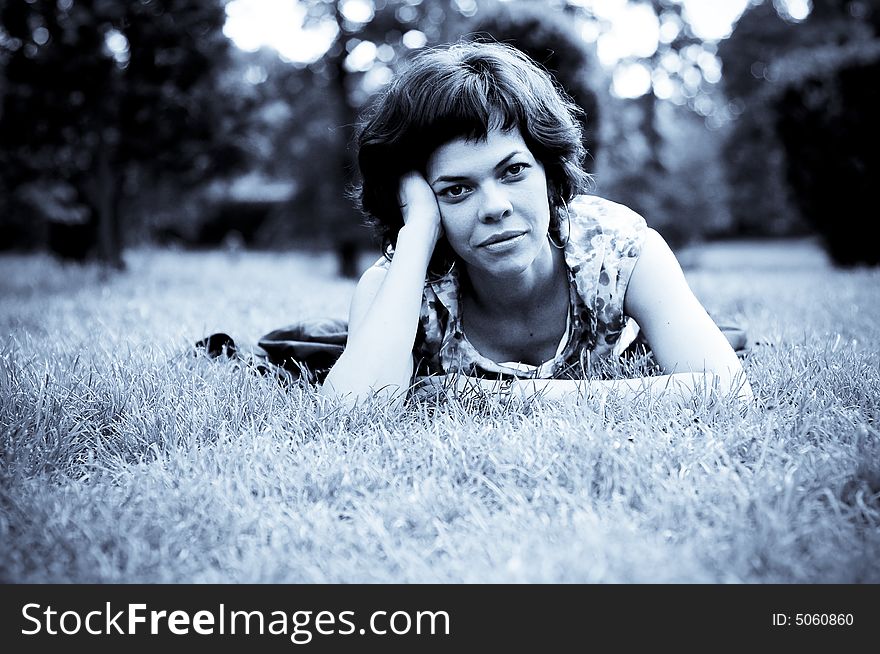 Young woman laid in grass