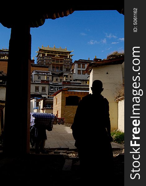 A Lama is walking into Songzanlin Monastery, Shangrila, Yunnan, China. A Lama is walking into Songzanlin Monastery, Shangrila, Yunnan, China.