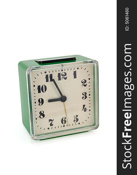Green mechanical alarm clock isolated on white
