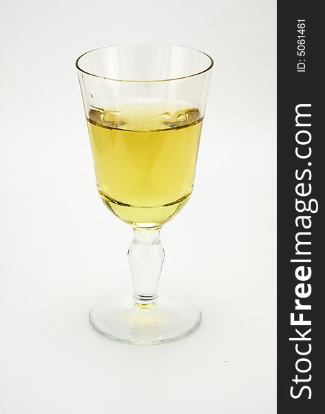 A glass of white wine on white background