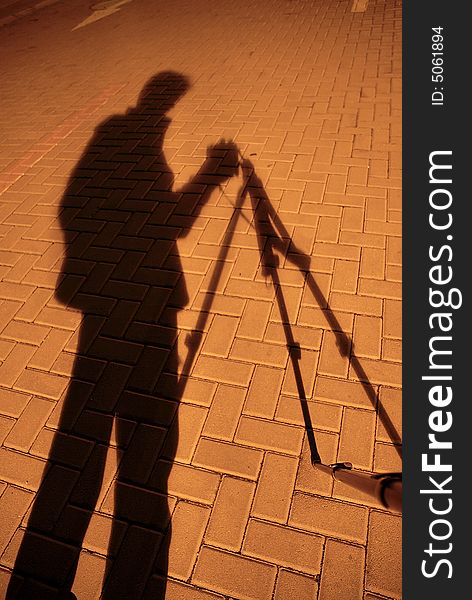 A silhouette of a photographer in night