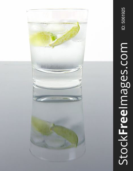 A glass of soda water with a slice of lime