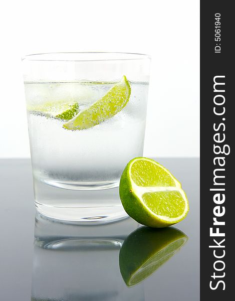A glass of soda water with a slice of lime
