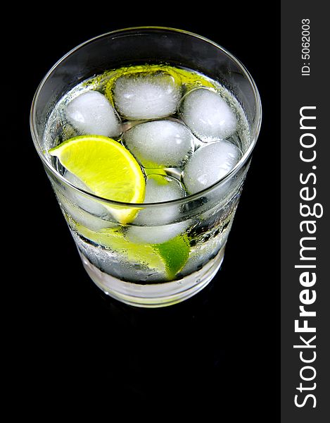 A glass of soda water with a slice of lime