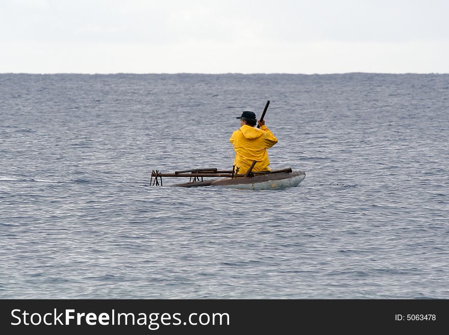 Traditional fisherman setting out in outrigger canoe. Traditional fisherman setting out in outrigger canoe