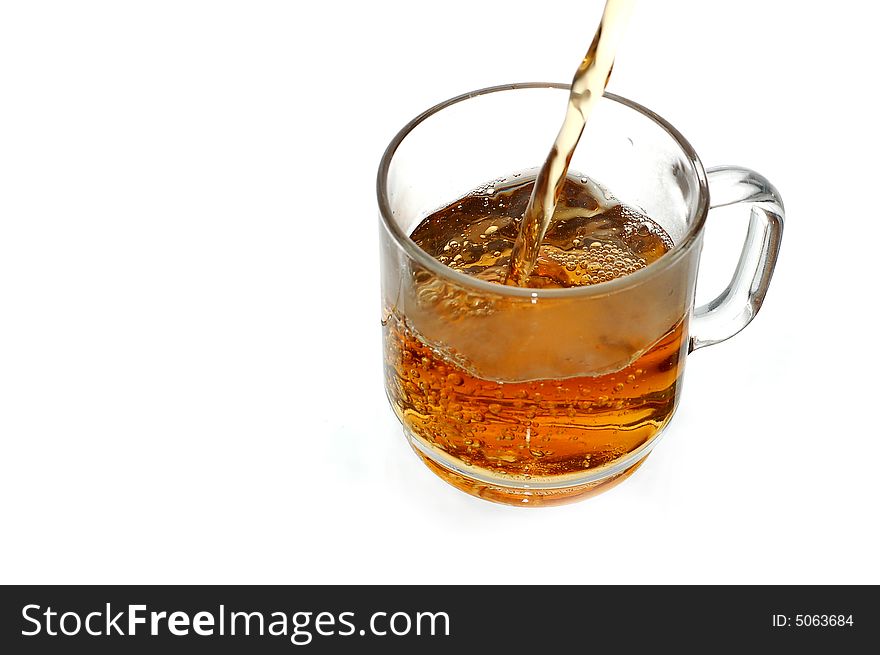 Pouring tea into glassy tea cup. Pouring tea into glassy tea cup