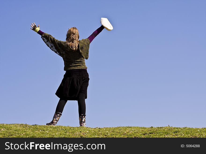 Young girl with raised arms on the grass. Young girl with raised arms on the grass