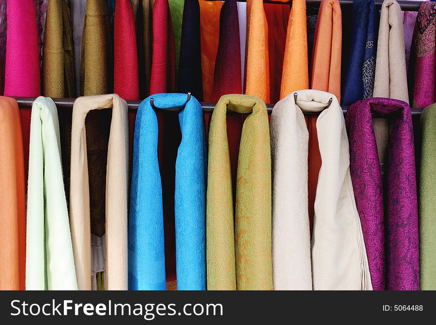 Row of colorful scarves at an Asian market - travel and tourism.