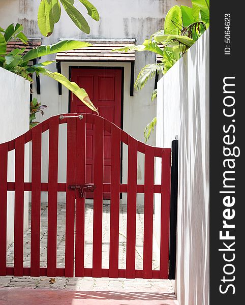 Pretty red fence and door at the entrance of a home. Pretty red fence and door at the entrance of a home.