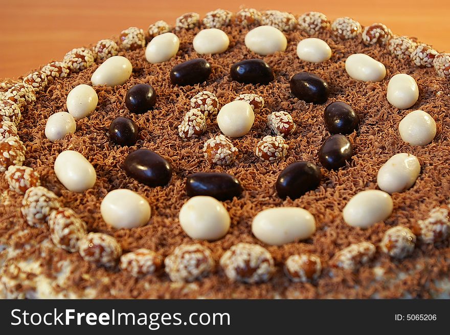 The celebratory ornate chocolate cake on a table. The celebratory ornate chocolate cake on a table