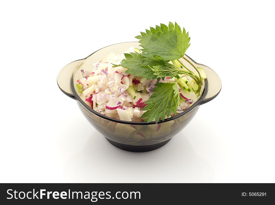 Chopped onion, radish, cucumber in a bowl with nettle leaves. Chopped onion, radish, cucumber in a bowl with nettle leaves