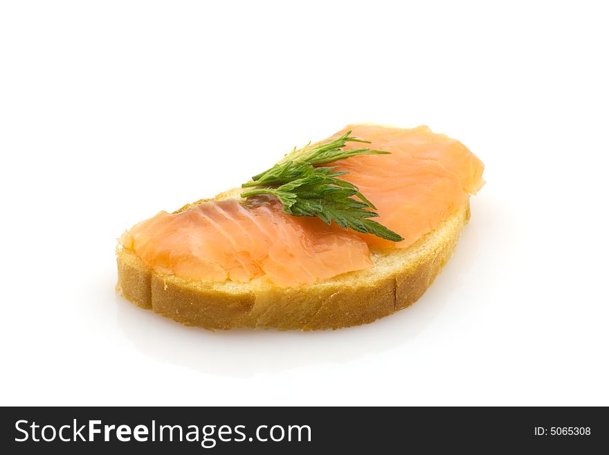 Closeup of smoked salmon on white bread with nettle leaf. Closeup of smoked salmon on white bread with nettle leaf