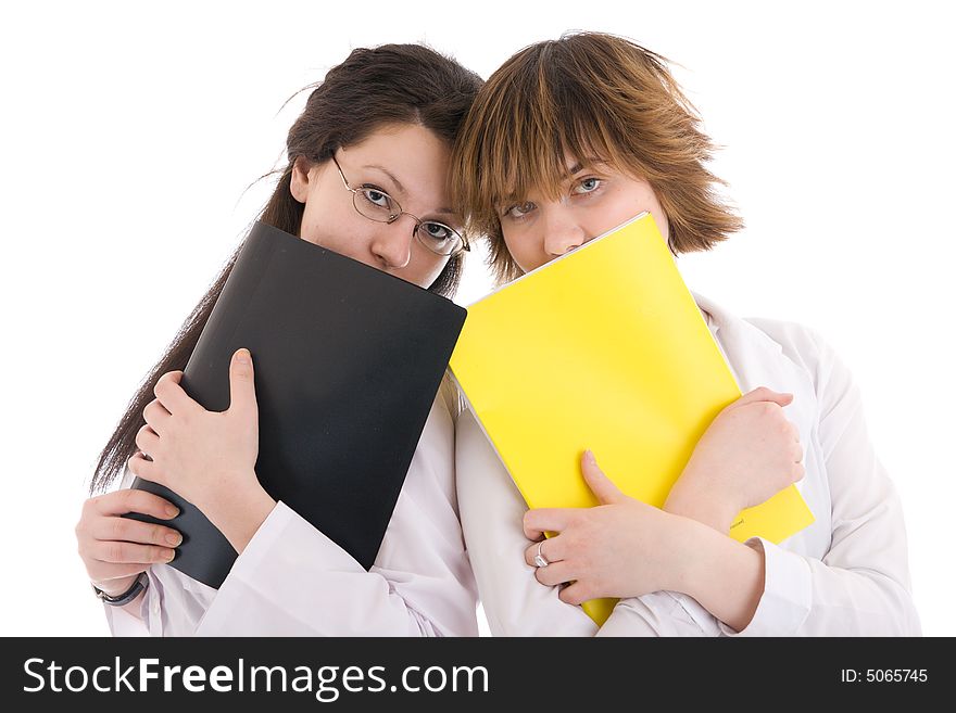 The two young attractive nurse with a folder isolated on a white background. The two young attractive nurse with a folder isolated on a white background