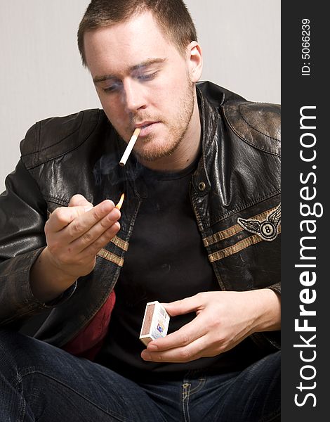 Portrait of young man smoking a cigarette