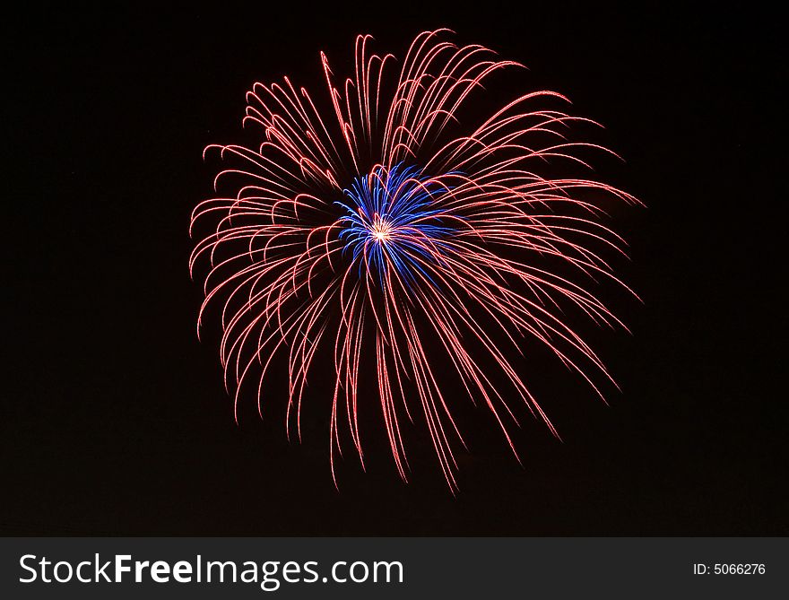 Red and blue fireworks on the black sky