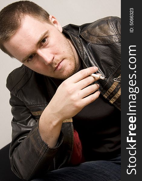 Portrait of young man smoking a cigarette