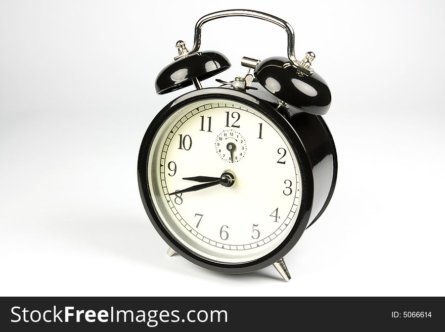 Classic alarm clock on white background