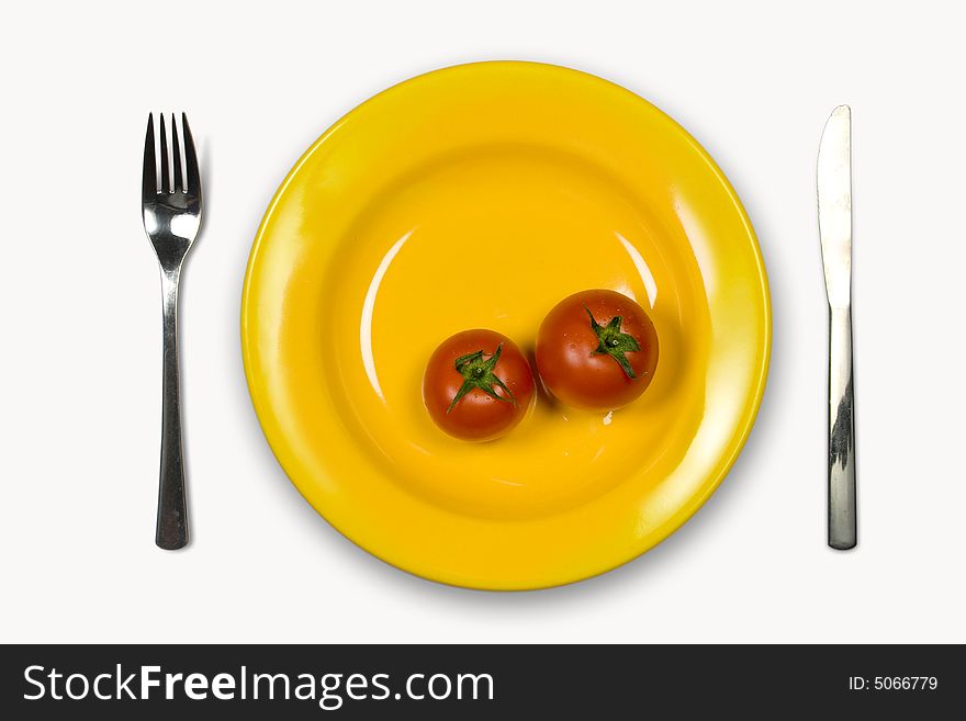 Ripe Tomatoes in yellow plate on white background