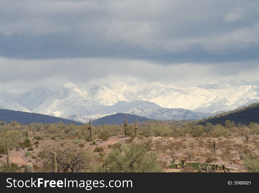 Snow covered mountain beyond the desert