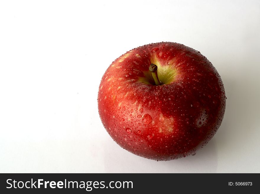 A wet apple over white background