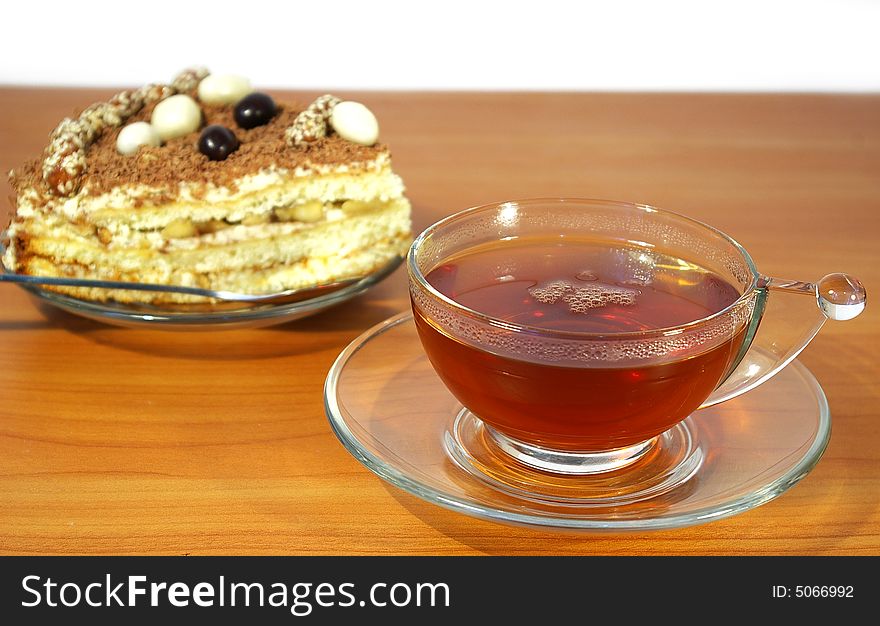 Cup of tea and cake isolated on white background. Cup of tea and cake isolated on white background