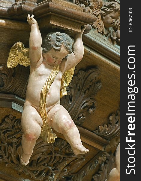 Statue of a little cherub in baroque church