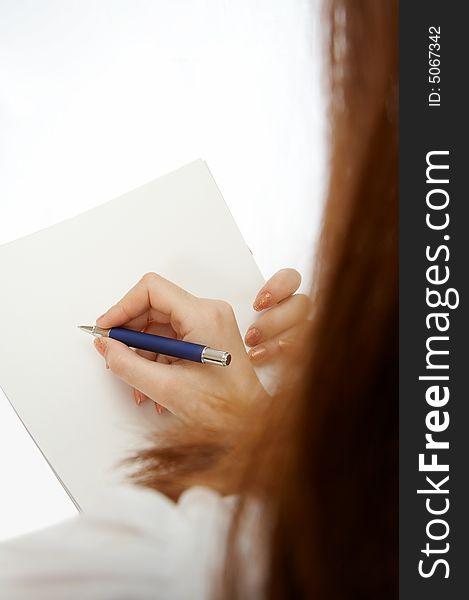 Hand of the woman signing the document